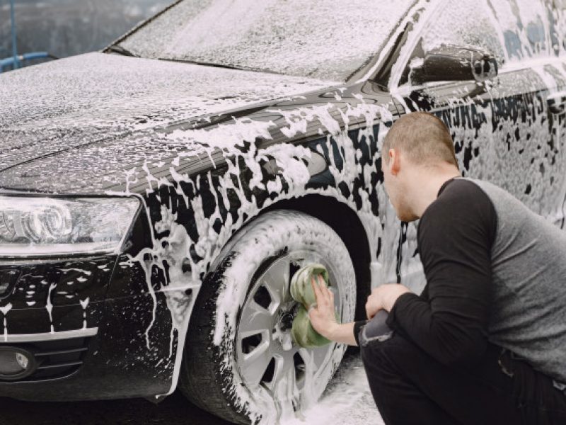 handsomen-man-black-sweater-washing-his-car_1157-35953